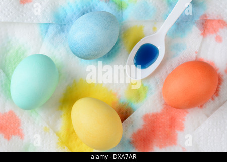 Angolo di alta vista di uova di Pasqua essiccazione su tovaglioli di carta. Gli asciugamani sono colorate con il colorante in eccesso. Formato orizzontale Foto Stock