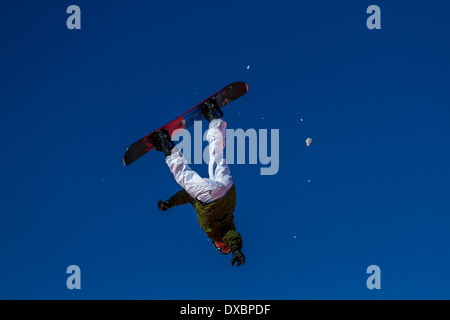Snowboarder che viaggiano attraverso l'aria Foto Stock