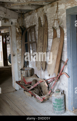 A tutta lunghezza vista di sled antichi appesi in una stalla a Curran Homestead, Orrington, Maine. Foto Stock