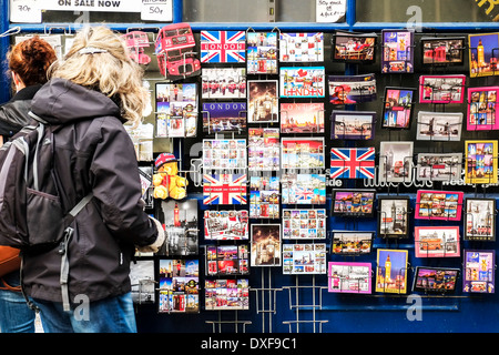 Un display di souvenir cartoline al di fuori di un negozio a Londra. Foto Stock