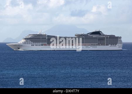 Una nave da crociera è la vela in mare di fronte a un'isola tropicale Foto Stock