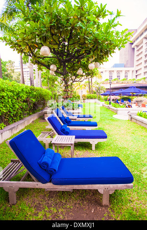 Blue chaise longue vicino alla piscina nel resort di lusso Foto Stock