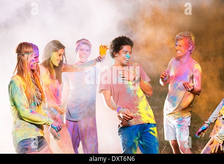 Amici coperti in gesso colorante a music festival Foto Stock