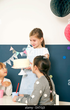 Ragazza alla festa di compleanno di servire la torta, Monaco di Baviera, Germania Foto Stock