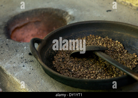 I chicchi di caffè La tostatura in una padella di ferro e fuoco aperto Foto Stock