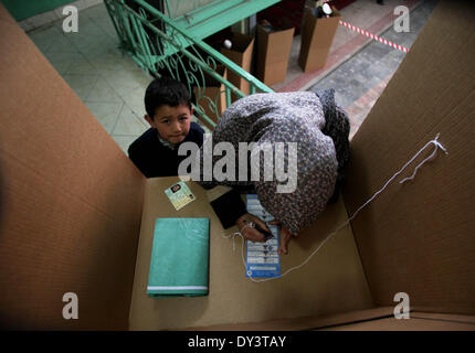 A Kabul, Afghanistan. 5 apr, 2014. Una donna afghana getta il suo voto a un centro di polling a Kabul, Afghanistan, il 5 aprile 2014. Il polling per l'Afghanistan elezioni presidenziali ha concluso il sabato e il conteggio dei voti ha iniziato, il paese di elezione hanno detto i funzionari. Un totale di 6,218 centri di polling è rimasto aperto su il giorno delle elezioni e circa 7 milioni di elettori, il 36 percento delle donne, aveva gettato i loro voti. Credito: Ahmad Massoud/Xinhua/Alamy Live News Foto Stock