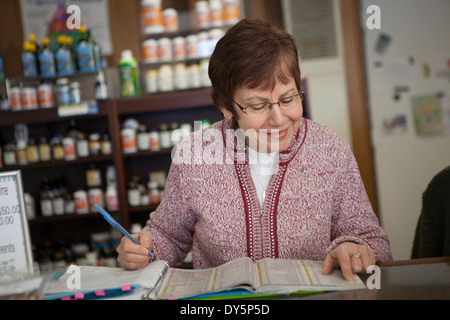 Health foods proprietario del negozio facendo di documenti cartacei Foto Stock