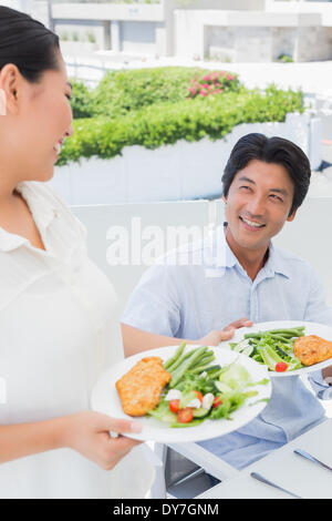 Donna che serve un pasto per il suo fidanzato Foto Stock