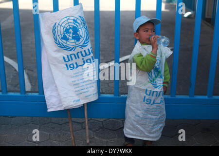 La striscia di Gaza, Territori palestinesi. 9 Apr 2014. Palestinesi prendere parte a una manifestazione di protesta contro la decisione presa dall'Ente soccorso e lavori delle Nazioni Unite (UNRWA) a ridurre le forniture di aiuto alimentare di fronte al quartier generale dell'UNRWA di Gaza City, il 9 aprile 2014. © Majdi Fathi/NurPhoto/ZUMAPRESS.com/Alamy Live News Foto Stock