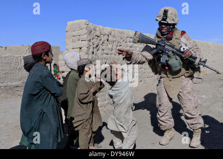 US Marine Corps Lance Cpl. Autayvia K. Mitchell con un innesto femmina team gioca con bambini afgani durante una pattuglia nel villaggio di Tajik Khar 18 dicembre 2009 nel distretto di Garmsir, provincia di Helmand, Afghanistan. Foto Stock