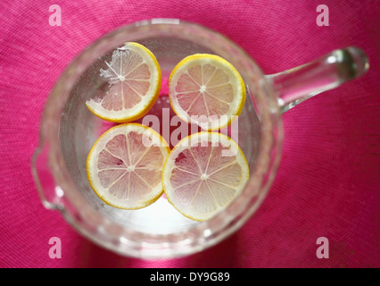 Fette di limone in una brocca di acqua. Foto Stock