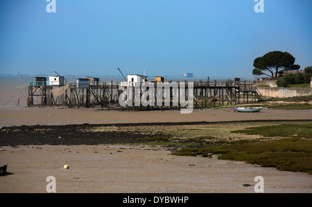 Tide fuori rivelando il letto del mare e devastata pier Foto Stock