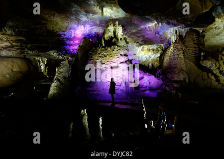 Un viaggiatore si erge nel mezzo di stalattiti illuminate dentro la metropolitana Kumistavi grotta, conosciuta anche come la grotta di Prometeo, vicino alla città di Tskaltubo nella regione di Imereti della Repubblica di Georgia Foto Stock