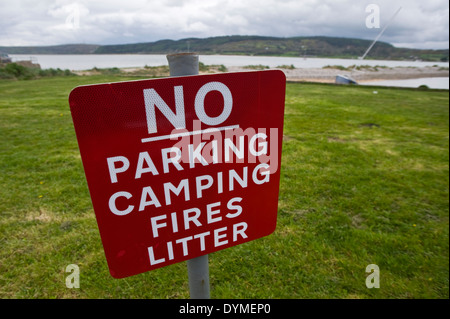 Nessun parcheggio camping incendi di lettiera al segno rosso Wharf Bay su Anglesey North Wales UK Foto Stock