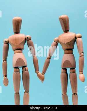 Giovane holding hands rappresentato dalle figure in legno, Londra Foto Stock