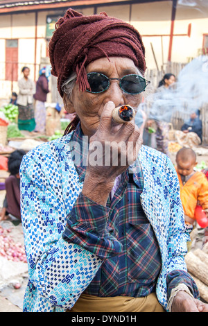 Signora fumatori di sigaro mercato in Bagan MYANMAR Birmania Foto Stock