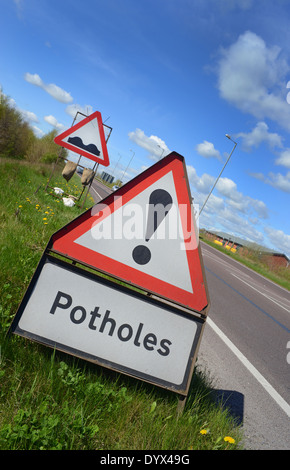 Segno di avvertimento di buche in strada regno unito Foto Stock