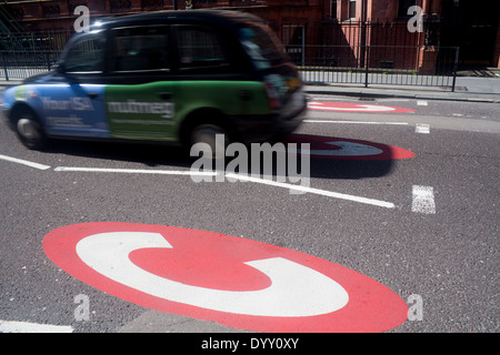 Tassa di congestione indicazioni Black taxi auto incrocio nel centro di Londra la congestione del traffico zona Gower Street Londra Inghilterra REGNO UNITO Foto Stock