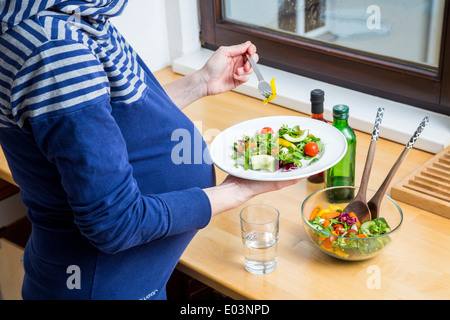 Donna incinta si prepara a cibo sano, un pasto sano. Foto Stock