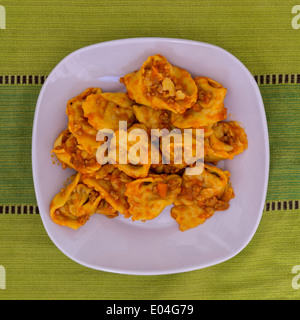 Cappellacci con ragù; pasta farcita con zucca (celebre piatto in Ferrara) Foto Stock