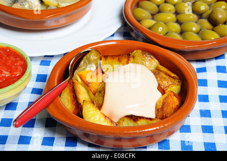 Tapas - scaglie di patate con maionese Patatas (bianche) con le olive verdi per la parte posteriore, Foto Stock