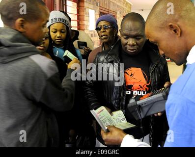 Pretoria, Sud Africa. Il 7 maggio, 2014. Un lavoratore personale controlla gli elettori' identità in corrispondenza di una stazione di sondaggio a Pretoria, Sud Africa, 7 maggio 2014. In Sud Africa il mercoledì ha dato dei calci a fuori dalla sua elezione generale che è la prima elezione durante il post-Mandela era. Credito: Li Qihua/Xinhua/Alamy Live News Foto Stock