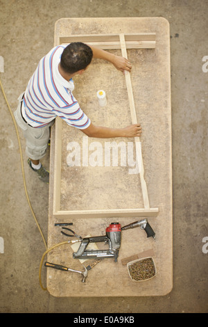 Tappezziere costruire un telaio di legno sul tavolo Foto Stock