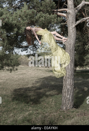 In Germania, in Baviera, Froettmaning Heath, giovane donna distesa su di un ramo Foto Stock
