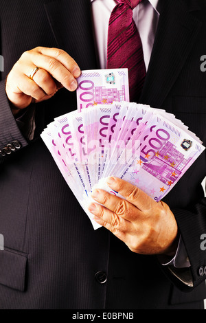 Un manager con un sacco di 500 euromoney per appunti in mano., Ein Manager mit vielen 500 Eurogeld Scheinen in der mano. Foto Stock
