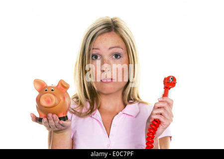 Una giovane donna con un salvadanaio e un flusso tappo. Foto simbolico costi per energia, Eine junge Frau Mit einem Sparschwein und ein Foto Stock