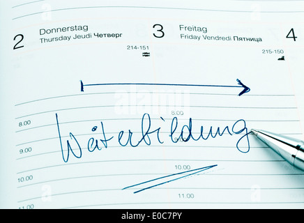 Un appuntamento viene messo giù in un calendario: formazione continua, Ein Termin ist in einem Kalender eingetragen: Weiterbildung Foto Stock