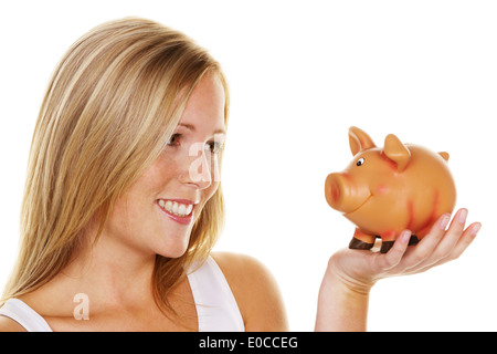 Una giovane donna consente di risparmiare denaro e di monete in euro per il futuro. Precauzione e salvare., Eine junge Frau spart Geld und Muenzen fuer die Zukunf Foto Stock