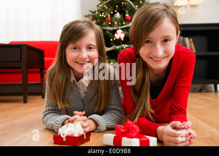 Sorelle (8-9, 10-11) in posa con i regali di Natale Foto Stock