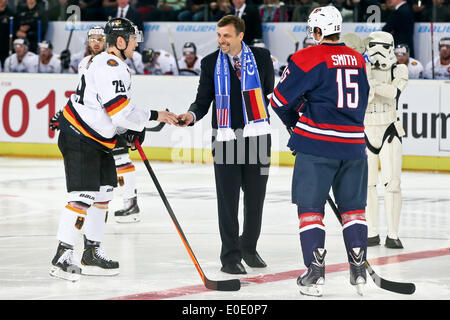 Norimberga, Germania. 06 Maggio, 2014. American Console generale a Monaco di Baviera Bill Moeller (2-L) trattiene il puck accanto alla Germania di Alexander Barta (L) e usa il Craig Smith durante il campionato del mondo di hockey su ghiaccio preparazione match tra la Germania e gli Stati Uniti a Arena Nuernberg in Nuremberg, Germania, 06 maggio 2014. A Storm Trooper da Star Wars si erge a destra con un Yoda figura sul suo braccio. Foto: Daniel Karmann/dpa/Alamy Live News Foto Stock