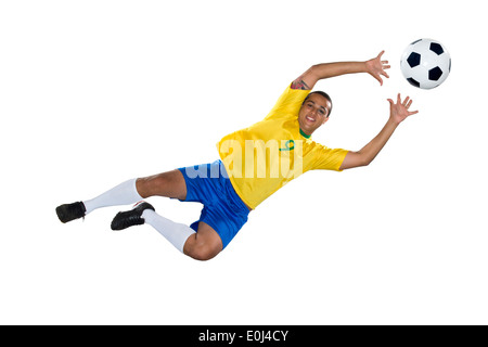 Calcio brasiliano player, saltando, giallo e blu Foto Stock