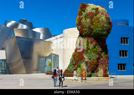 Vista turisti cucciolo flower includono arte floreale di Jeff Koons al Museo Guggenheim di Bilbao, Paesi Baschi Foto Stock