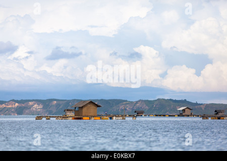 Capanne galleggianti utilizzati per coltivare i frutti di mare - scenario della baia di Ekas, visto dalla regione di Ekas, Lombok, Indonesia Foto Stock