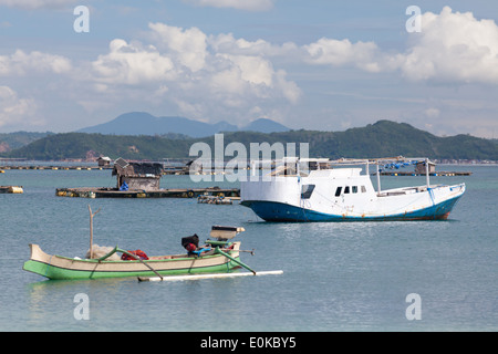 Barche e capanne flottante (utilizzato per far crescere i frutti di mare) - scenario della baia di Ekas, visto dalla regione di Ekas, Lombok, Indonesia Foto Stock