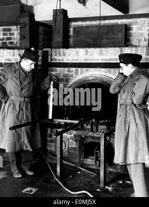 Gli americani nella parte anteriore della camera del gas al campo di concentramento di Dachau Foto Stock