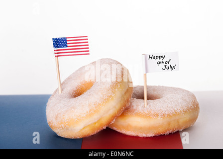 Due ciambelle con bandiera americana e un Banner bianco con felice 4 di luglio, isolato Foto Stock