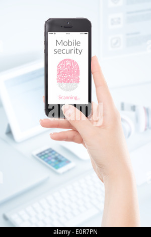 Woman hand is scanning fingerprint by modern black smartphone. Mobile security concept. Foto Stock