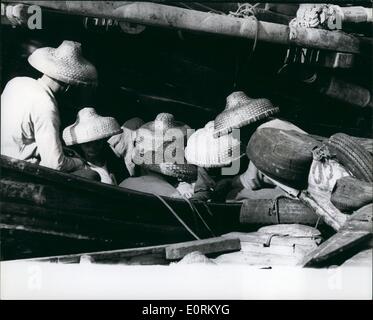 1° gennaio 1960 - Aberdeen Village, città di pescatori di Hong Kong che esiste quasi immutata da oltre 100 anni, è recentemente diventata un centro per i turisti a causa del suo porto galleggiante piuttosto stretto e i visitatori devono essere trasportati lì dalla riva da ''Samans''', che sono tenuti piuttosto occupati a andare avanti e indietro da terra a nave. Gli inhaitnts di Aberdeen trascorrono gran parte del loro tempo sull'acqua, pescando o spostandosi avanti e indietro tra le varie altre isole. Sotto questi grandi cappelli si nascondono i pescatori, seduti sulla loro barca e che giocano a carte. Foto Stock