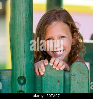 Close up della Cute girl accanto alla recinzione di legno. Foto Stock