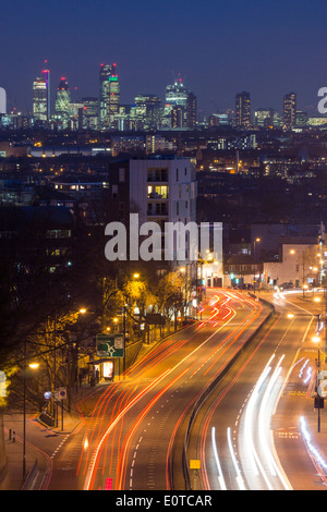 Vista dal ponte ad arco a Londra dello skyline della città e di Shard di notte con i percorsi del traffico su strada in primo piano Londra Inghilterra REGNO UNITO Foto Stock