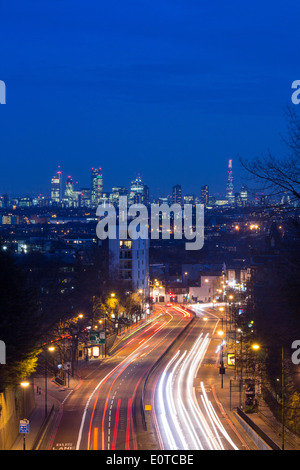 Vista dal ponte ad arco a Londra dello skyline della città e di Shard di notte con i percorsi del traffico su strada in primo piano Londra Inghilterra REGNO UNITO Foto Stock