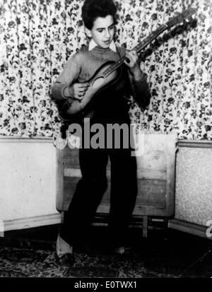 Beatle George Harrison come un bambino a suonare la chitarra Foto Stock