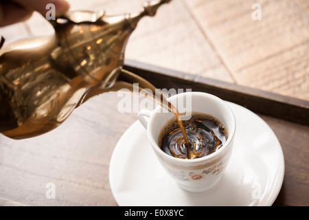 Caffè versata da una pentola in una tazza Foto Stock