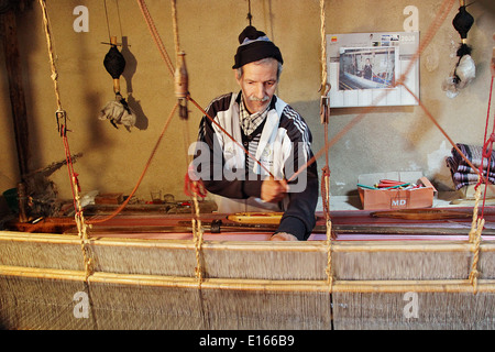 Uomo in Fes tessitura stoffa di seta Foto Stock