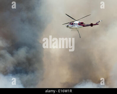 San Onofre, California, Stati Uniti d'America. 14 Maggio, 2014. Un Orange County Fire Autorità di gocciolamento di acqua Bell UH-1 Super Huey elicottero combatte la Pendleton West Freeway Fire a San Onofre State Park in California Mercoledì, 14 maggio 2014. © David Bro/ZUMAPRESS.com/Alamy Live News Foto Stock