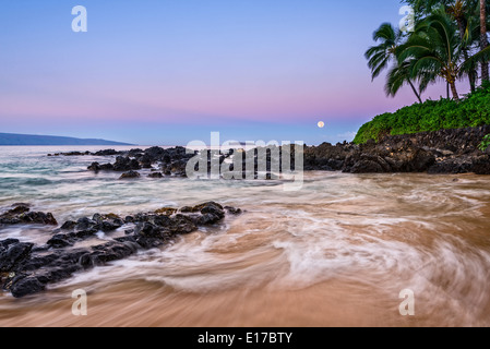 Alba con la luna più bella e appartata spiaggia segreta di Maui, Hawaii. Foto Stock